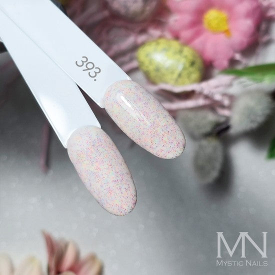 Mystic Nails 393 gel polish with glittery finish on a blurred floral background, brand 'Mystic Nails' visible.